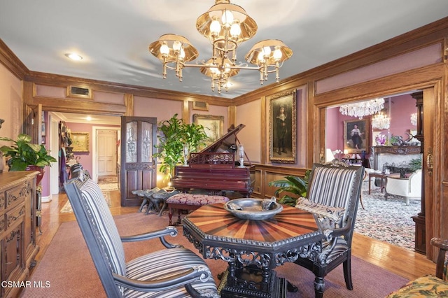 dining room featuring crown molding, light hardwood / wood-style flooring, and a chandelier