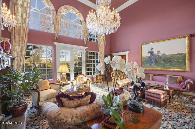 living room with a high ceiling, an inviting chandelier, and ornamental molding