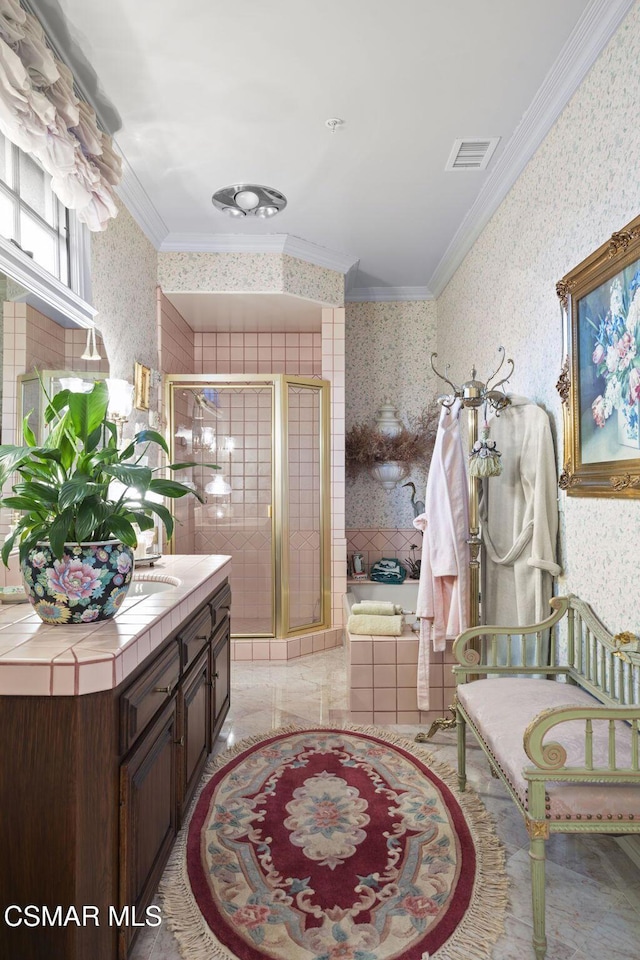 bathroom featuring vanity, a shower with shower door, crown molding, and tile walls