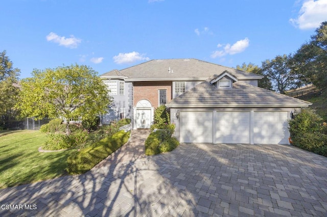 view of front of house with a garage and a front lawn