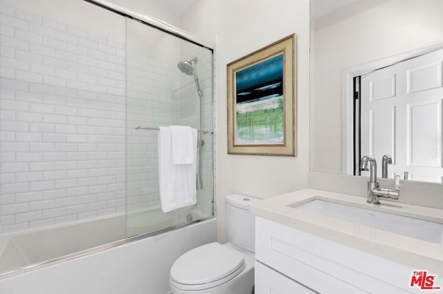 full bathroom with vanity, toilet, and shower / bath combination with glass door