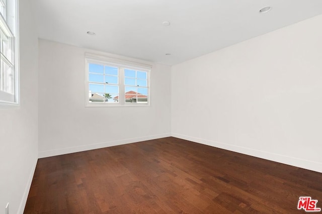 empty room featuring dark hardwood / wood-style flooring