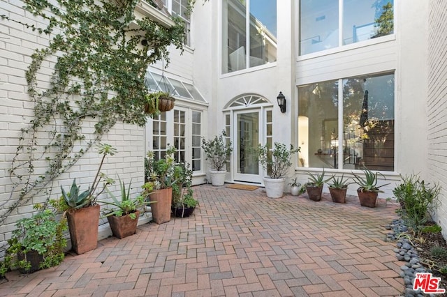 view of exterior entry featuring a patio and french doors