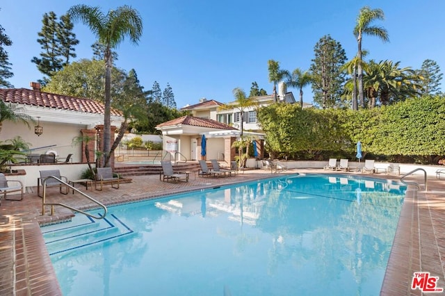 view of swimming pool featuring a patio area