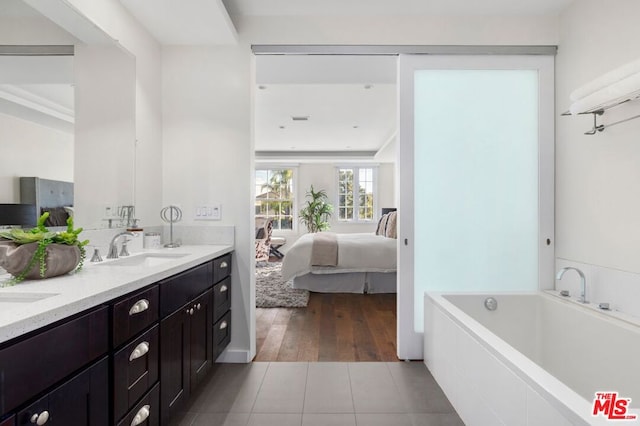 bathroom featuring a bathtub, vanity, and hardwood / wood-style flooring