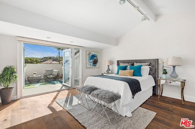 bedroom with dark hardwood / wood-style flooring, lofted ceiling, rail lighting, and access to outside