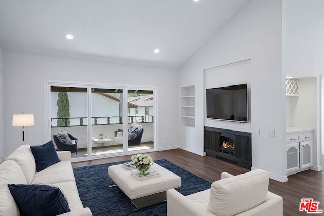 living room featuring built in shelves, high vaulted ceiling, and dark wood-type flooring