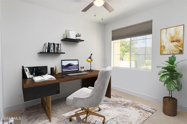 carpeted home office featuring ceiling fan