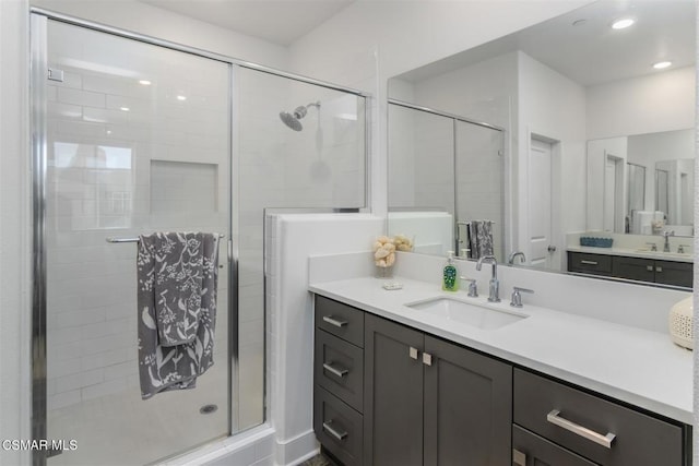 bathroom with vanity and a shower with door