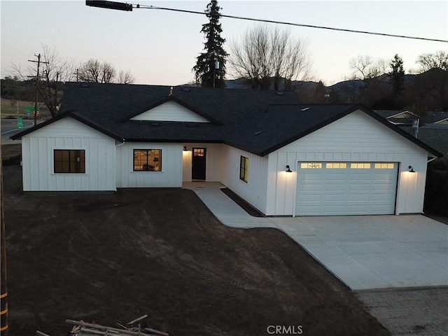 modern inspired farmhouse with a garage