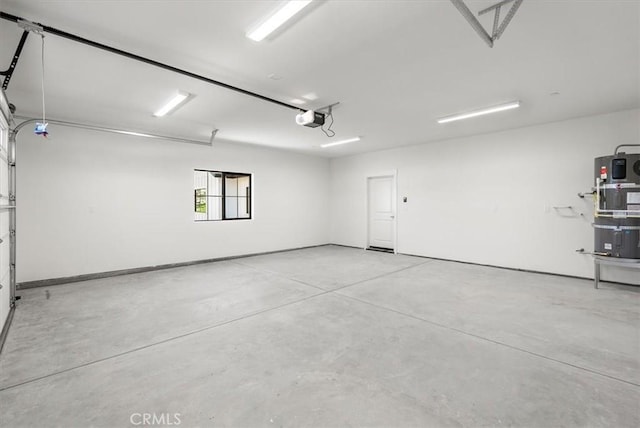 garage featuring strapped water heater and a garage door opener