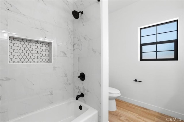 full bath featuring toilet, shower / bathing tub combination, baseboards, and wood finished floors