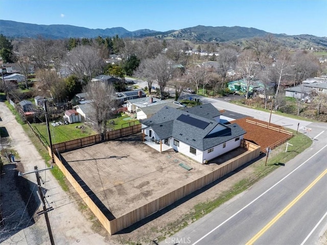 drone / aerial view featuring a residential view and a mountain view