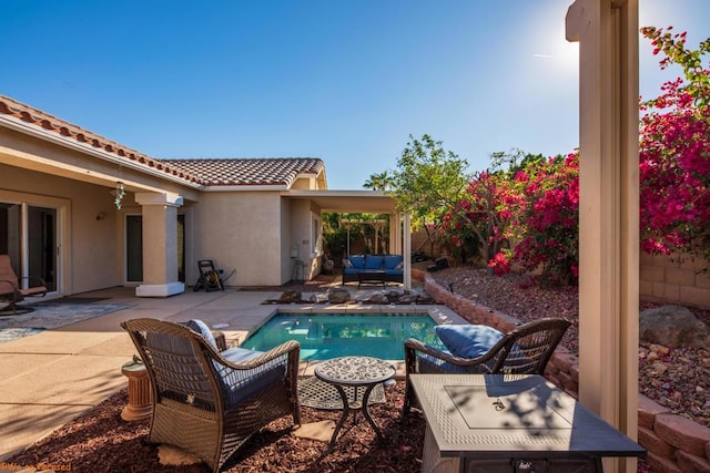 view of pool featuring an outdoor living space and a patio area