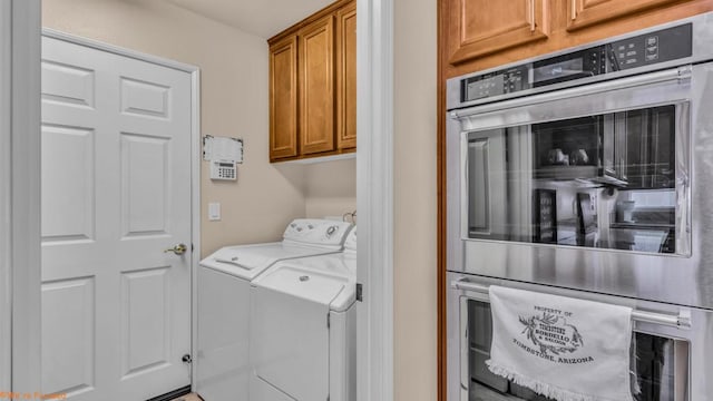 clothes washing area with washer and dryer