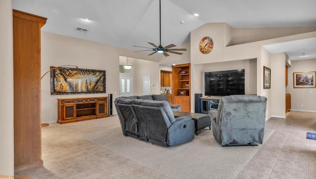 tiled living room featuring ceiling fan and lofted ceiling