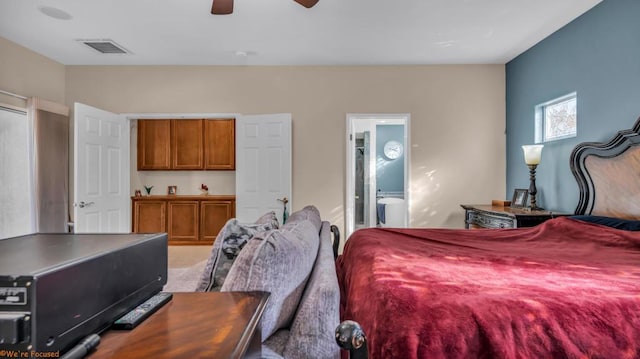 bedroom with ceiling fan and ensuite bath