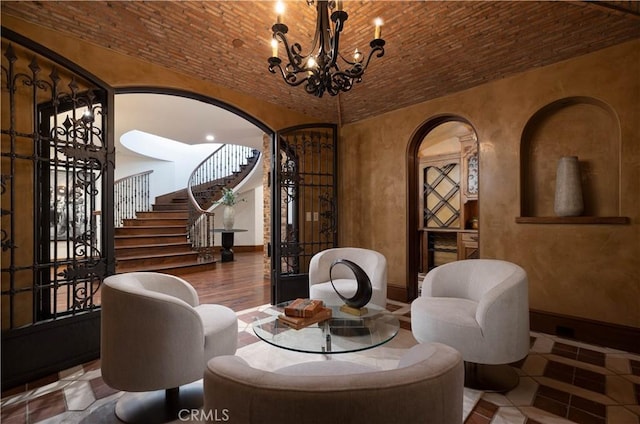 interior space featuring tile patterned floors, brick ceiling, and a notable chandelier