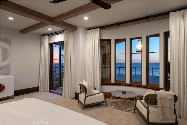 carpeted bedroom featuring beam ceiling, a water view, and ceiling fan