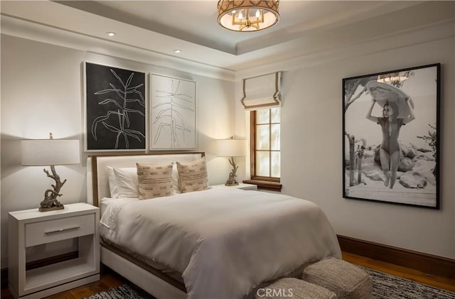 bedroom with dark hardwood / wood-style floors