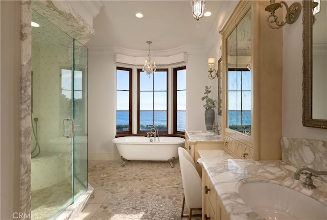 bathroom with plenty of natural light, a water view, ornamental molding, and independent shower and bath