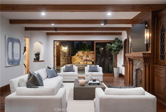 living room with beam ceiling, a fireplace, and dark hardwood / wood-style floors