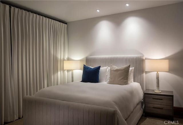 bedroom with dark colored carpet