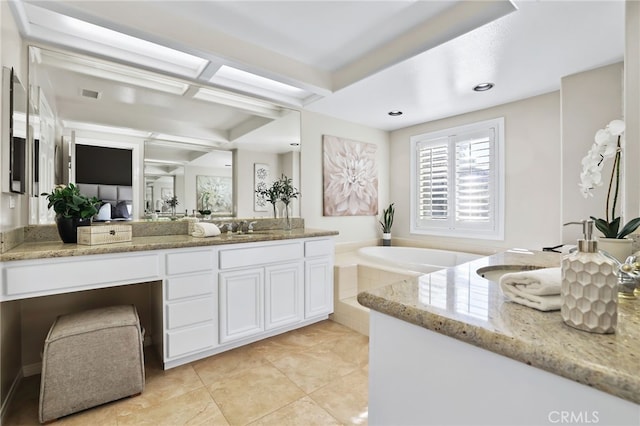 bathroom with a bathtub, vanity, and tile patterned flooring