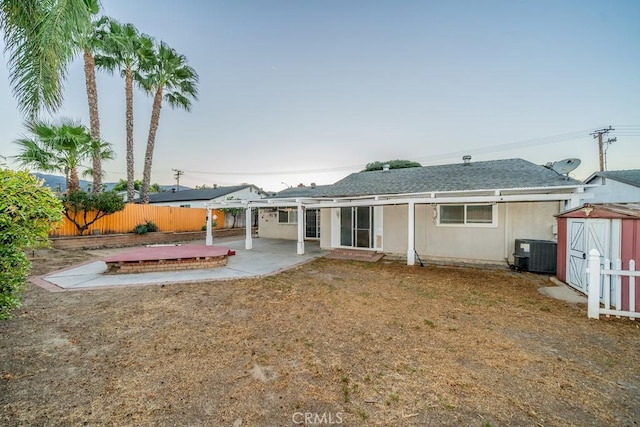 back of property featuring central AC unit and a patio area