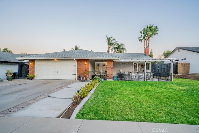 single story home featuring a yard and a garage