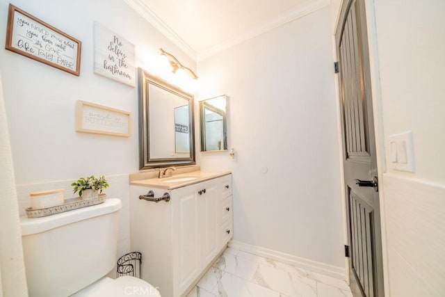 bathroom with vanity, toilet, and crown molding