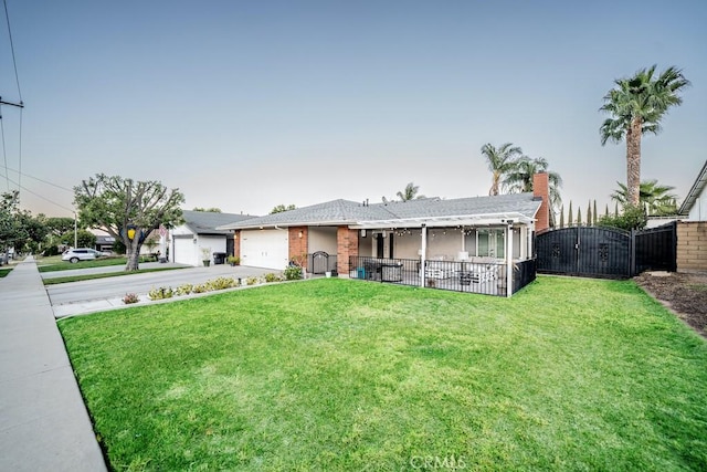 ranch-style house with a garage and a front lawn