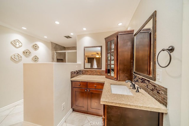 bathroom with vanity, tile patterned flooring, ceiling fan, tasteful backsplash, and a shower with shower door