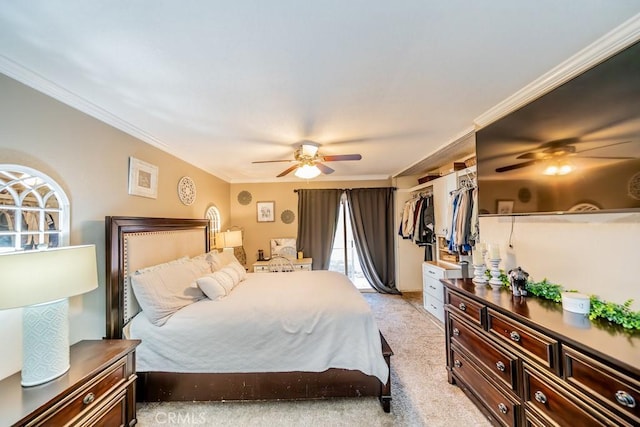 carpeted bedroom featuring a closet, crown molding, and ceiling fan