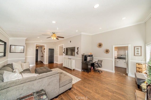 living room with hardwood / wood-style floors, ceiling fan, and ornamental molding