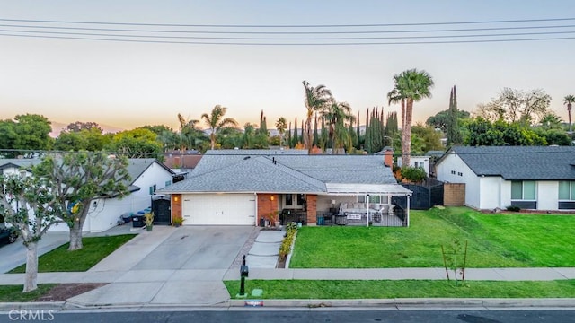 view of front of house with a yard and a garage