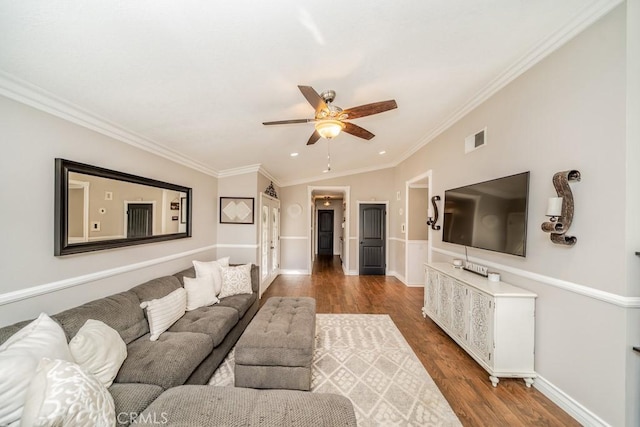 living room with hardwood / wood-style floors, ceiling fan, crown molding, and vaulted ceiling