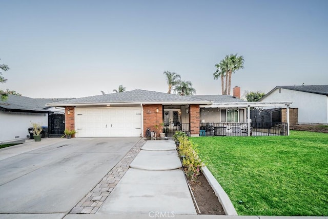 single story home with a garage and a front lawn