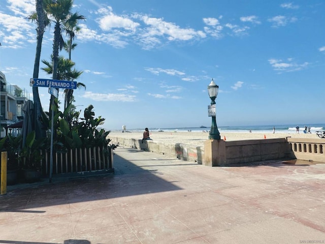 view of street with a water view and a view of the beach