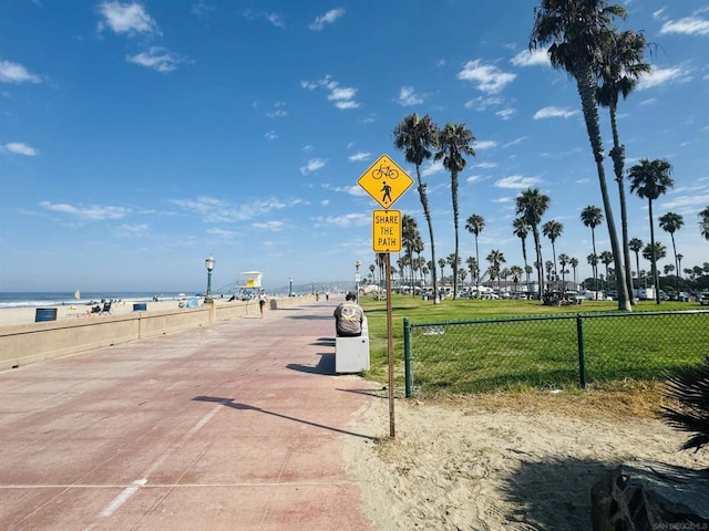 surrounding community featuring a water view and a view of the beach