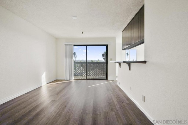 empty room featuring wood-type flooring and a textured ceiling