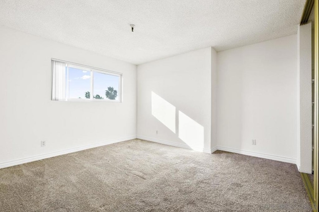 empty room featuring carpet flooring and a textured ceiling