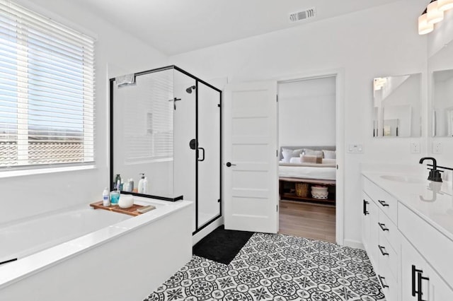 bathroom featuring vanity, independent shower and bath, and tile patterned flooring