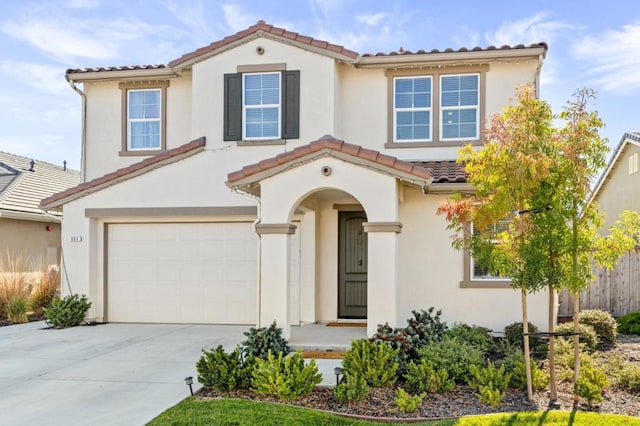 mediterranean / spanish-style house with a garage