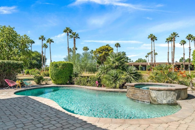 view of swimming pool featuring an in ground hot tub and a patio