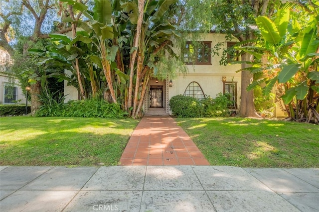 mediterranean / spanish-style home with a front lawn