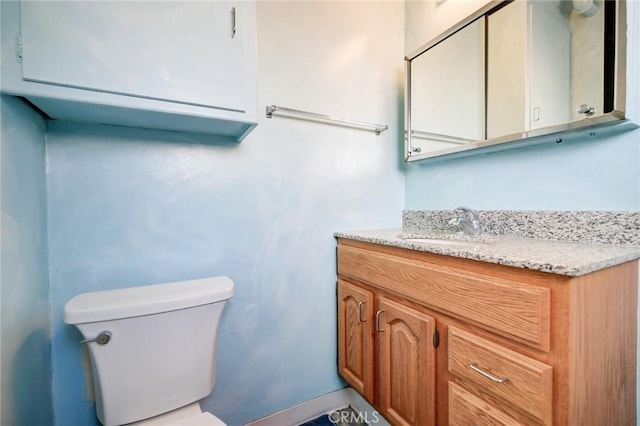 bathroom with toilet and vanity