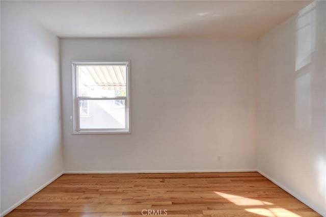 spare room featuring light hardwood / wood-style floors