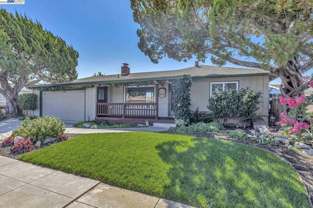 single story home featuring covered porch, a garage, and a front lawn