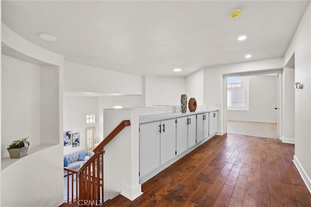 hallway with dark hardwood / wood-style flooring